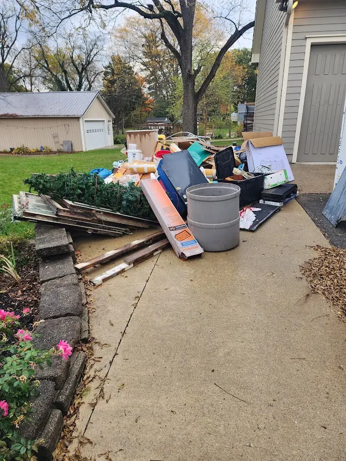 Dumpster being loaded with debris for Roofing Dumpster Rental in The Meadows